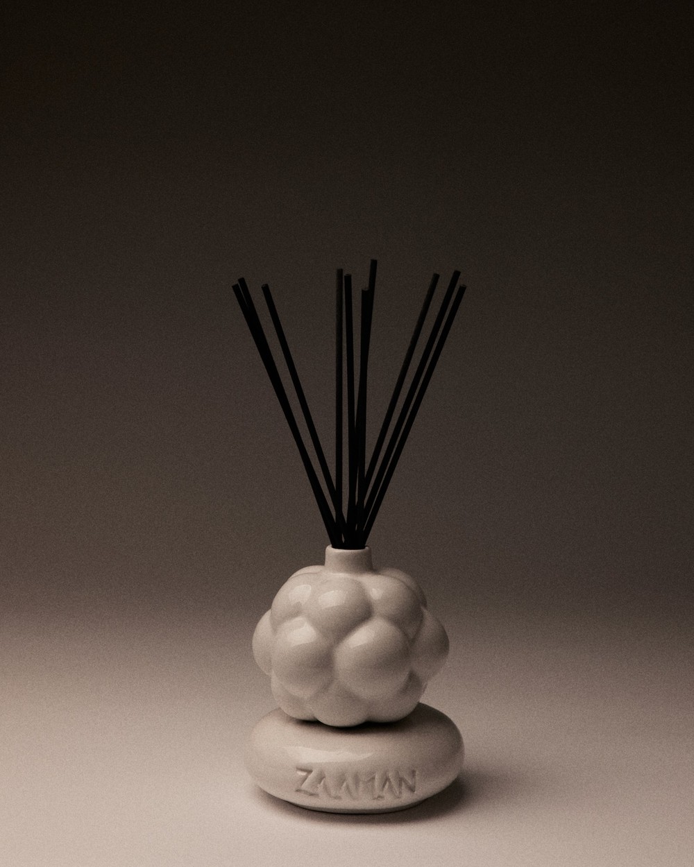 White Zaaman Cloud 9 ceramic vessel with reed sticks, studio